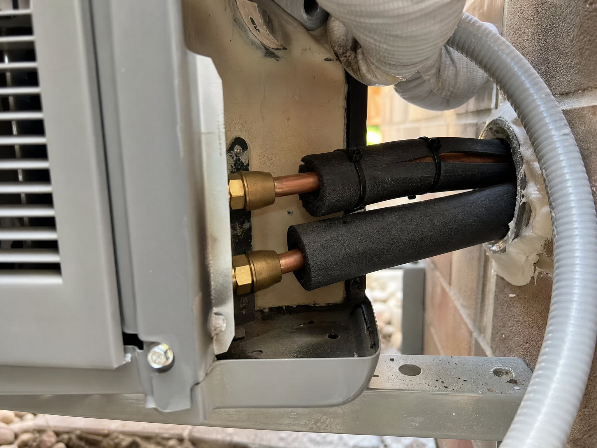 Close-up detail of materials and technique used in heat pump replacement — showing quality