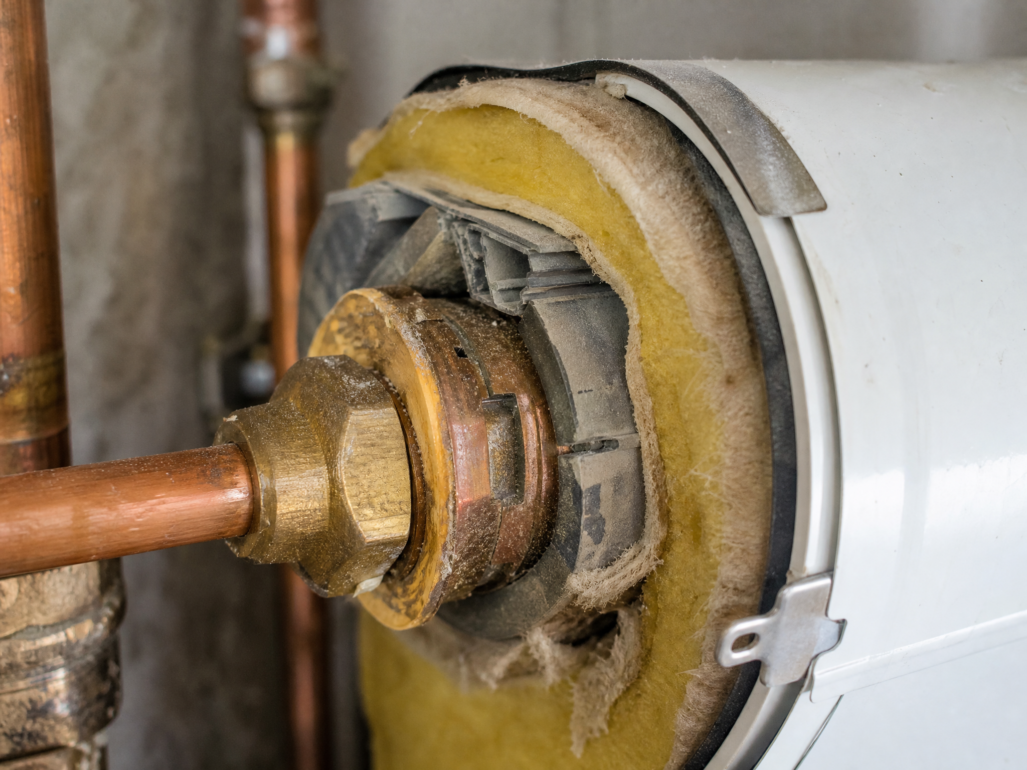 Close-up detail of materials and technique used in hot water cylinder installation — showing quality